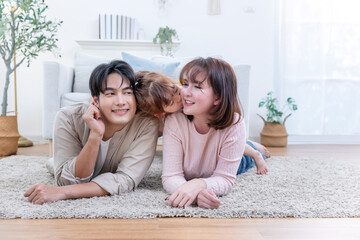 Asian family enjoys spending their time together in a living room