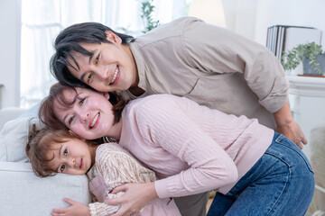 Asian family enjoys spending their time together in a living room