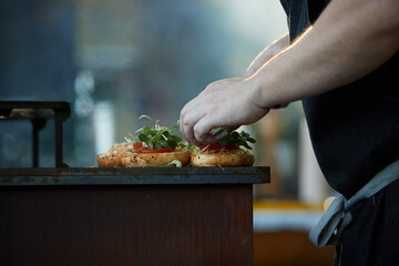 Catering staff serving prepared meals from a buffet line during a professional event, ideal for: corporate catering, hospitality services, food service operations, business events.