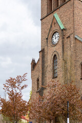Kampen Church Neo Gothic Brick Architecture in Oslo Norway with Clock Tower and Springtime Budding Trees in Kampen Neighborhood