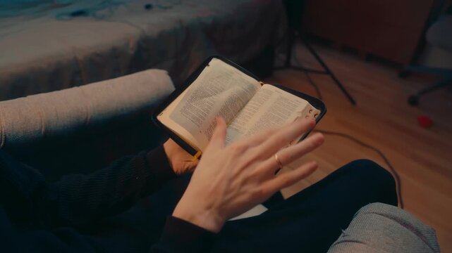 Top view hands flipping Bible pages searching scripture