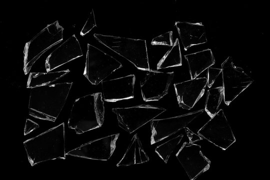 broken glass. several pieces of broken glass isolated on a black background