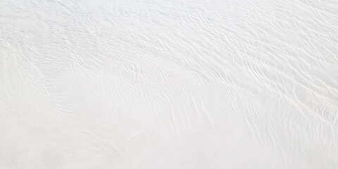 Obraz premium Clear water and white sand background. Rippled surface texture. Abstract natural banner backdrop.