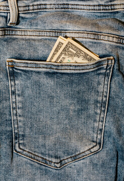 Dollars in denim jeans pocket close-up