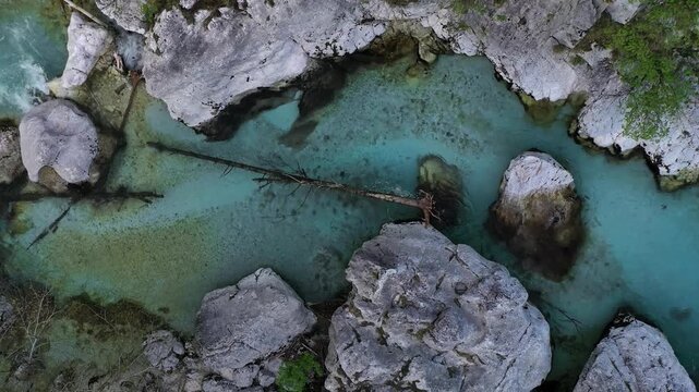 Turquoise Soca River and wooden bridge aerial view