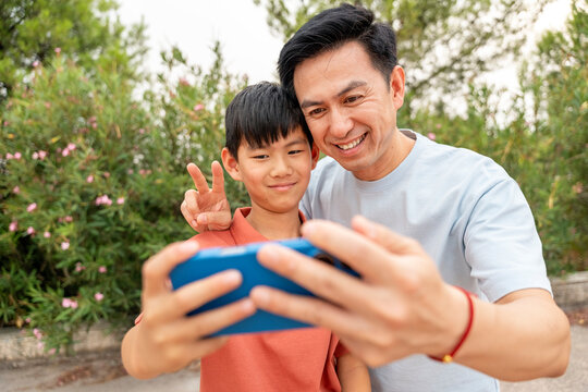 Chinese father and son enjoying time outdoors
