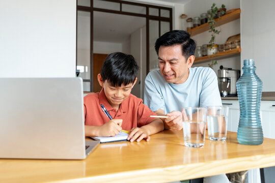 Father and son bonding during study time at home