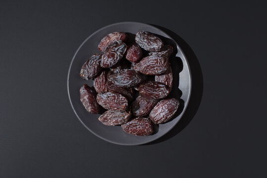 Medjool dates on a black background
