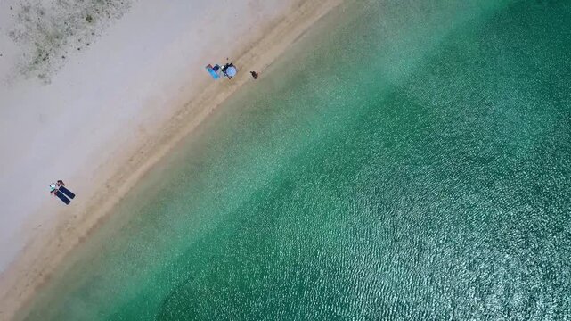 Rocky islet in turquoise sea aerial view