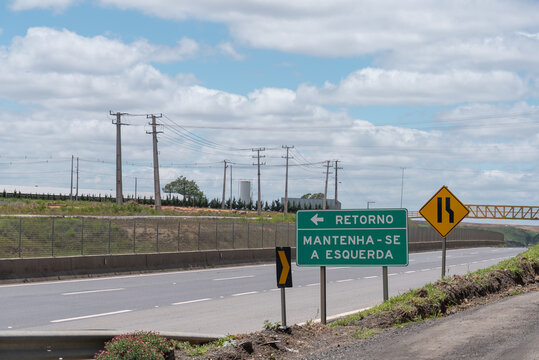 Green Road Sign in Brazil Indicating Left Direction