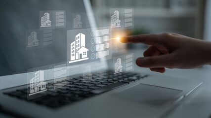 A user interacts with a laptop displaying virtual real estate elements, showcasing the blend of...