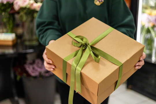 Florist holding a beautifully wrapped gift box