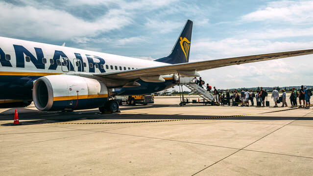 Leeds, UK - 21 July 2025: A Ryanair passenger aircraft parked on the airport apron at Leeds Bradford Airport in the UK, with passengers boarding the plane, illustrating low-cost air travel in Europe.
