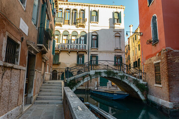 Empty canal with bridge and historic buildings in Venice, Italy © Diego