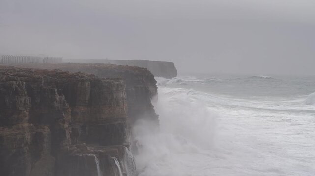 Dramatic footage of powerful Atlantic Ocean waves crashing violently against the cliffs of Sagres in the Algarve, Portugal during Storm Kristin. 