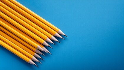 Fototapeta premium Yellow Pencils In Aligned Diagonal Row On Blue