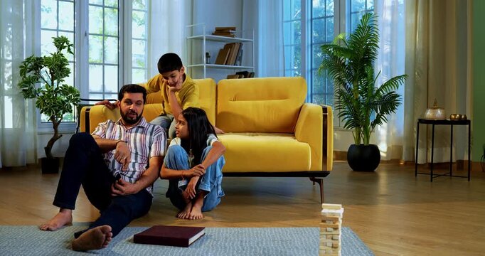 Indian family together drinks cold drink in glass as mother serves refreshing beverages to husband and kids while everyone enjoys happy bonding time indoors in modern lavish home