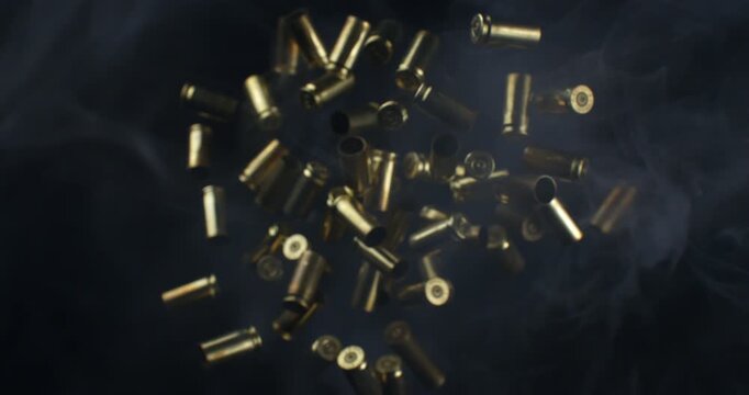 Slow Motion Macro Shot Of Brass Bullet Casings Burst On Black Background. Concept Of Ammunition, Industry And Impact