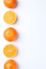 Fototapeta premium Fresh ripe tangerines on white background, flat lay. Space for text