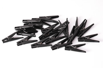 Set of black plastic clothespins on a white background