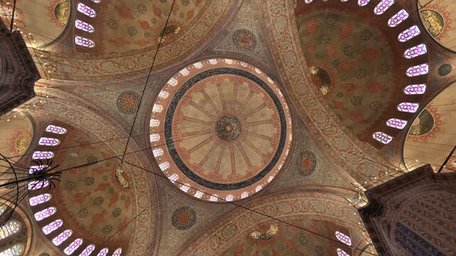 Istanbul, Turkey, August 6, 2025. A rotating view of the majestic, ornate dome and arches of the Sultan Ahmed Mosque, or Blue Mosque. The interior is decorated with intricate patterns and calligraphy.