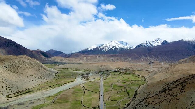 Aerial Highway Through Sichuan-Tibet Mountains with Snow-Capped Peaks