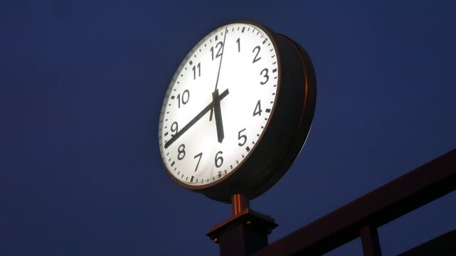 Large Outdoor Clock Showing Time on a Metal Post Outdoors Representing Public Timekeeping
