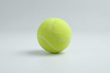Bright Yellow Tennis Ball on White Surface