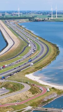 cluster dark modern visitor buildings integrated into landscape historic grassy bunkers winding footpaths sit major highway afsluitdijk netherlands near architecture 
