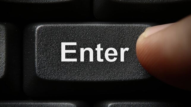 Close up of a finger pressing the enter key on a black computer keyboard for confirmation