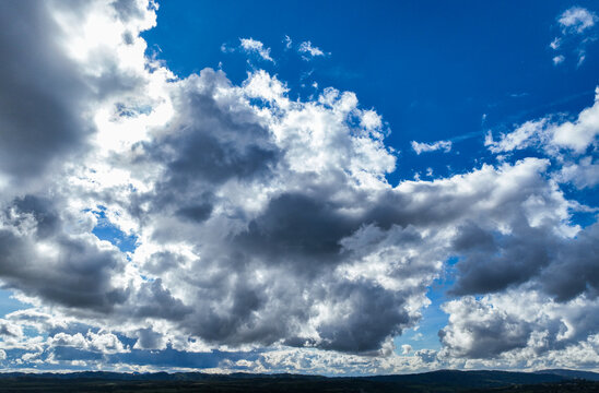 A Beautiful Cloudy Sky with the Sun Behing the Dark Part of the Clood