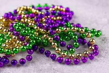 Vibrant Mardi Gras background with mask, beads, and festive decorations