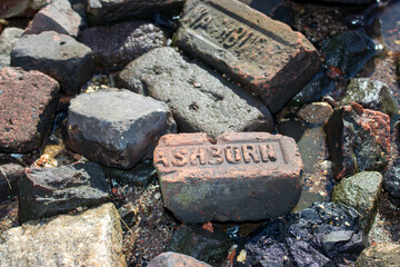 Weathered Brick and Stones Along a Shoreline