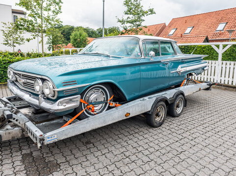 6 july 2025,Maribo, Denmark. Chevrolet impala, turquoise color scheme with white hard top, hardtop sedan. Vintage car fixed on a trailer for transport.. Typical American classic car with a striking co