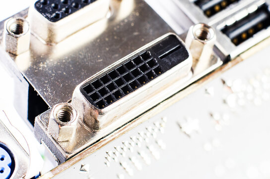 Close-up of DVI connector and computer motherboard ports with screws