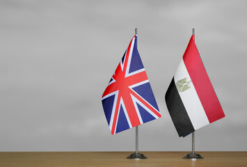 Table flags United Kingdom and Egypt on grey blurred background