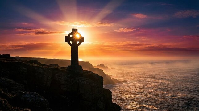 Celtic cross overlooking the ocean at sunset with vibrant colors  