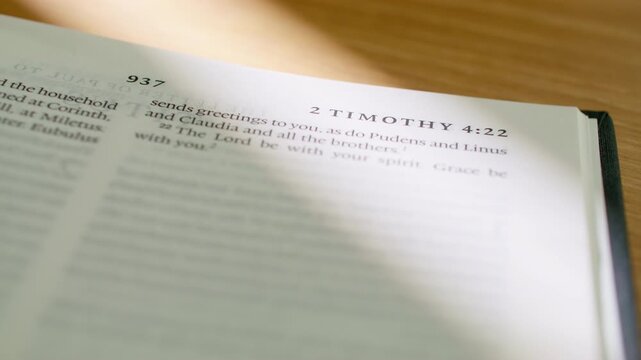 Bible pages flipping from 2 Timothy to Titus book. Turning pages between the New Testament pastoral letters epistles regarding ministry, leadership, and good works study. 4K close up shot