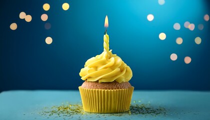 Yellow Birthday Cupcake With Burning Candle And Blue Background