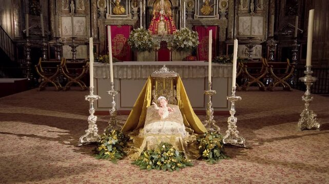 Statue of the infant Jesus before an altar in the cathedral of Seville, Spain