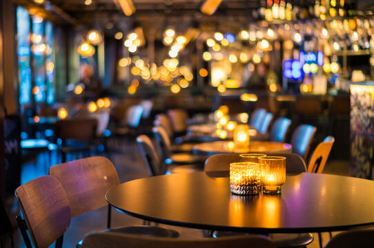 Warm Ambient Lighting in a Stylish Modern Restaurant with Candlelit Tables Creating a Cozy Evening Atmosphere