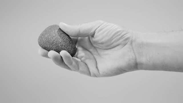 Polished Neolithic Stone Axe in Hand, Prehistoric Artifact Heritage. slow motion. 4k at 50 fps. black and white. 