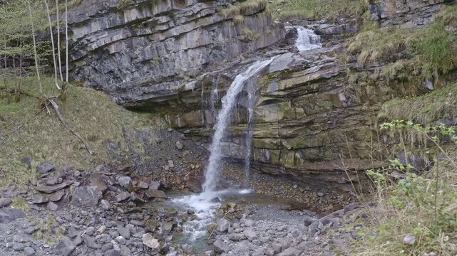 Waterfall in the mountains. Water falls from the from cascades. Bottom part of Diesbachfall waterfall, canton Glarus, Switzerland.