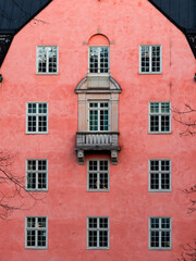 Fototapeta premium Building exterior with a lot of windows and pink wall.