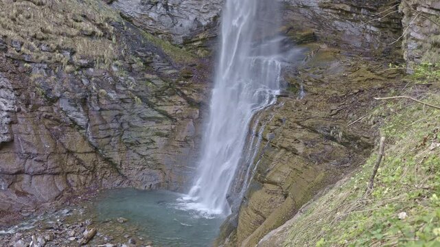 Waterfall in the mountains. Water falls from the from cascades. Middle part of Diesbachfall waterfall, canton Glarus, Switzerland.