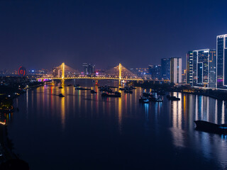 Obraz premium Aerial view of Guangzhou at night: illuminated skyline and bridge pear river reflections, neon light
