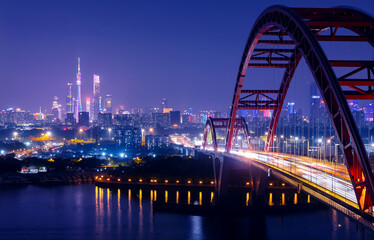 Obraz premium Aerial night view of Guangzhou cityscape with illuminated red bridge and skyline. Travel photo of Guangdong China