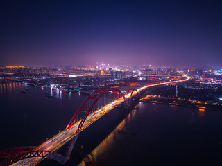 Obraz premium Aerial nightscape of Guangzhou, illuminated skyline and bridges with traffic jam of car