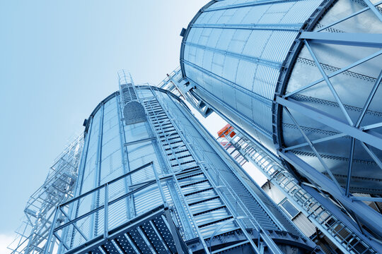 Industrial agricultural silos for storage and drying of grains, wheat, corn, soy, sunflower, blue tinting.