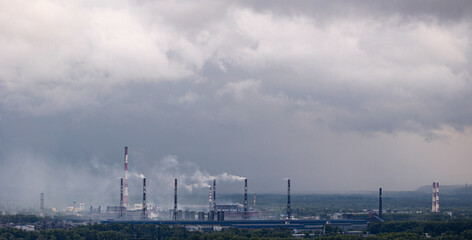 Obraz premium Air pollution smog from power factory plant chimneys smoking pipe sunset. Concept industry environmental problems.